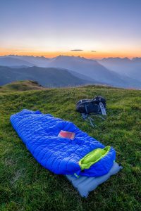 blue sleeping bag on mountain