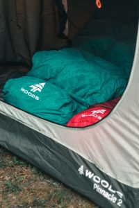 green sleeping bag inside tent
