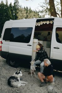 couple car camping with dogs
